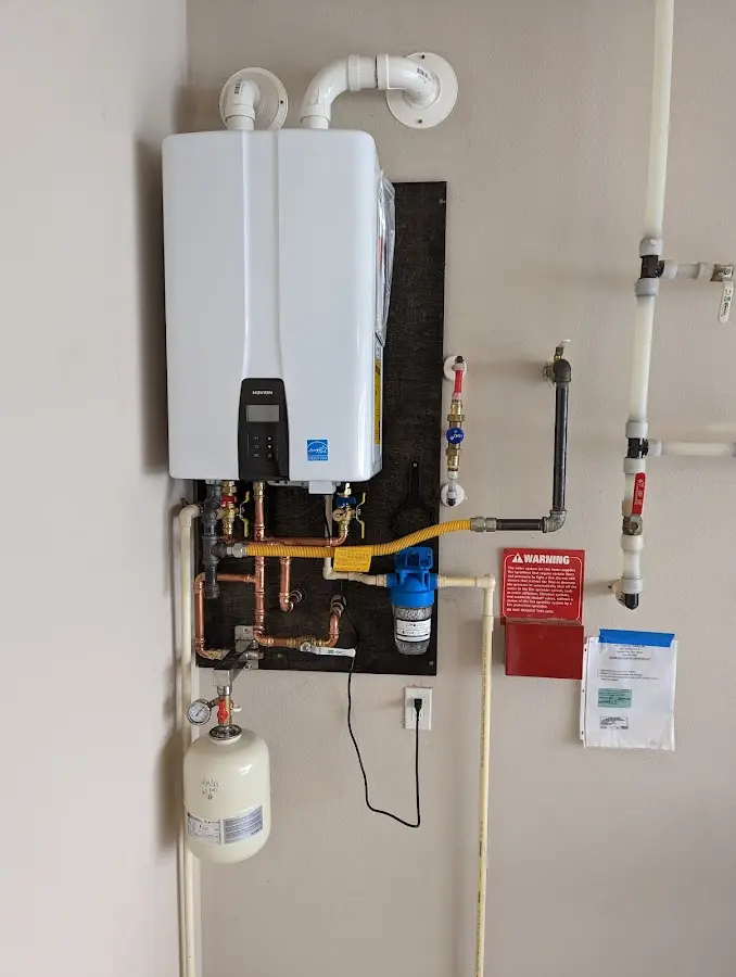 Professional plumber installing copper piping in a Coshocton home